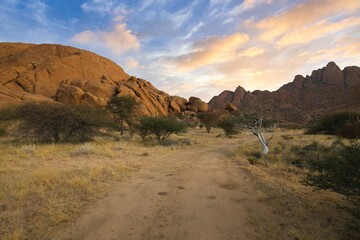 Wall Mural - Sunrise in calm morning in Spitzkoppe, panoramic, desert landscape of famous red, granite rocks, Namibia, Africa 