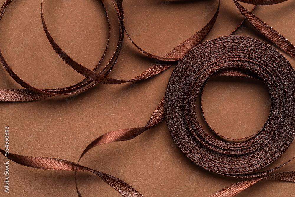 Skein of ribbon on brown background