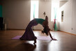Yoga postures demonstrated by a strong gentle, yoga teacher in her studio. 