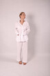 © Шамиль Алиев - Young girl in white house clothes on a white background in the studio