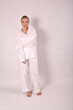 © Шамиль Алиев - Young girl in white house clothes on a white background in the studio