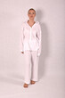 © Шамиль Алиев - Young girl in white house clothes on a white background in the studio