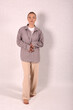 © Шамиль Алиев - A young girl in beige home clothes on a white background in the studio