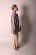 © Шамиль Алиев - A young girl in beige home clothes on a white background in the studio