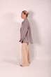 © Шамиль Алиев - A young girl in beige home clothes on a white background in the studio