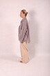 © Шамиль Алиев - A young girl in beige home clothes on a white background in the studio