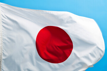 Wall Mural - Japan flag waving on blue background