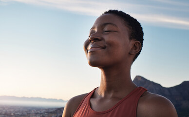 fitness, calm and breathing of black woman outdoor in nature, mountains and blue sky background for 