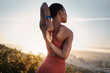 © C Malambo/peopleimages.com - Fitness, black woman and stretching arm on mountain in Cape Town for muscle wellness, healthy goals and energy. Athlete, warm up and mobility for workout, sports exercise and start training in nature