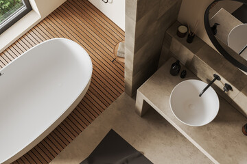 Top view of light bathroom interior with sink and tub with accessories