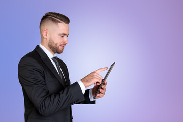 Poster - Businessman using tablet in hands on gradient empty background
