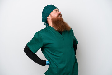 Wall Mural - Surgeon redhead man in green uniform isolated on white background suffering from backache for having made an effort