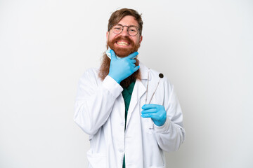 Wall Mural - Dentist reddish man holding tools isolated on white background happy and smiling