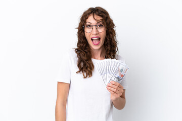 Wall Mural - Young woman with curly hair taking a lot of money isolated background on white background with surprise facial expression