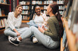 © Kay A/peopleimages.com - Education, students or women friends on library floor for comic conversation, learning or book study. Diversity, happy or girl with smile for university support, college research or school project