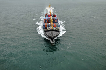 Impressive aerial wide angle view of a container ship crossing the oceans