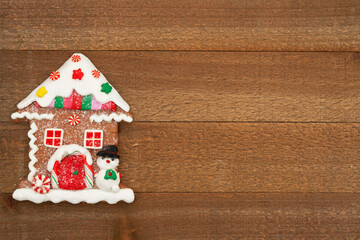 Wall Mural - Christmas gingerbread house on weathered wood holiday background