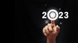 © captain - Finger pressing blue start 2023 button on virtual interface  with copy space for text. Concept of new year. Businessman pressing 2023 start up business. Beginning of New Year 2023