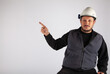 © vidiot - Man with white safety helmet pointing empty text area on isolated white background.