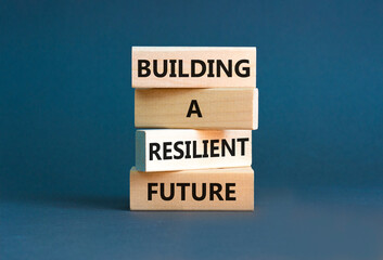 Building a resilient future symbol. Concept word Building a resilient future on wooden blocks. Beautiful grey table grey background. Business and building a resilient future concept. Copy space.