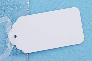 Wall Mural - Blank white gift tag on blue felt