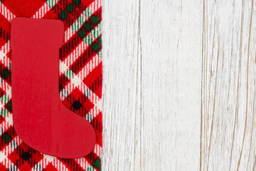 Canvas Print - Christmas stocking on buffalo plaid border material holiday background on weathered wood