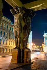 Wall Mural - Evening view of the black sculptures of Atlanteans at the entrance to the Hermitage in St. Petersburg