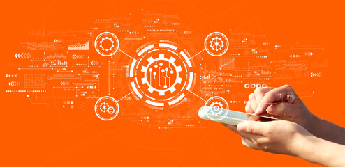 Automation concept with person using a smartphone on a orange background