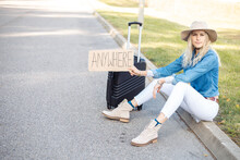 Tired Solitude Blond Woman Hitchhiking, Sitting On Curb By Highway Hold Cardboard Plate Anywhere With Baggage, Car Wait
