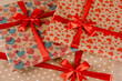© Rabizo Anatolii - Festive packaging for birthday celebration. Gifts with a red bow for party and silk ribbon for a party.