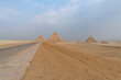 The three great pyramids of Giza seen from the road that passes next to them.