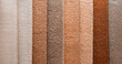 Variety of carpets and carpets of different colors on the stand in the store or the factory. Multicolored carpet samples