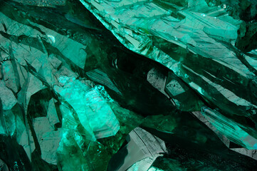 dioptase crystal macro detail texture background. close-up raw rough unpolished semi-precious gemsto