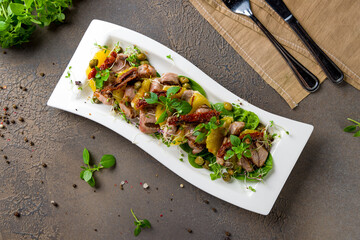 Wall Mural - salad with duck and greens on a white plate top view