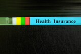 Fototapeta  - Health insurance file record in black binder folder. Health insurance benefit concept.