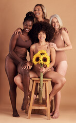 Wall Mural - Plus size women, lingerie and group portrait with sunflower for beauty, wellness and solidarity in studio. Model team, underwear and flowers with support hug, diversity and smile by studio backdrop