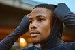 © S Fanti/peopleimages.com - Fitness, black man and hoodie in city running, exercise and workout for motivation, strong mindset and energy of healthy goals. Thinking, runner and sports athlete with focus to start cardio training