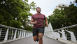 © S Fanti/peopleimages.com - Fitness, exercise and black man running in city for health and wellness. Sports, runner or young male from Nigeria jog, exercising and cardio workout outdoors on bridge training for marathon practice