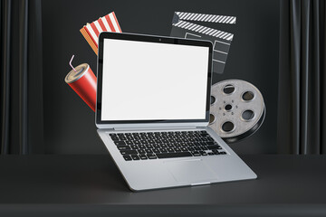 Poster - Online cinema movie watching concept with blank white modern laptop screen with space for your logo or text on dark cinema background with popcorn and film-strip. 3D rendering, mockup