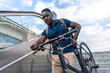 © Westend61 - Man carrying bicycle on staircase