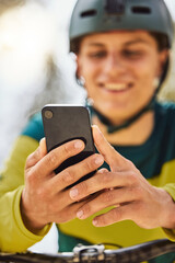 Cycling, bike and man with phone outdoor, texting or on social media. Sports, bicycle and male cyclist on break after training with 5g mobile smartphone for networking, internet browsing or messaging