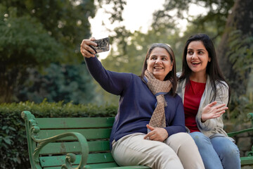 Two indian woman taking selfie at park