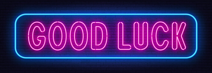 Good Luckneon sign on brick wall background.