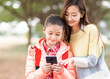 © Tom Wang - Happy mother and daughter watching the smart phone