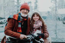 Portrait Of Grandfather And Granddaughter In Winter At Outdoor Ice Skating Rink.