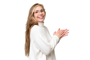 Wall Mural - Young blonde woman over isolated background applauding