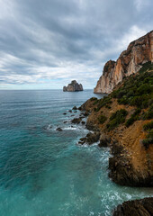 Wall Mural - vertical landscape of the cliffs and sea stacks at Porto Flavia on Sardinia