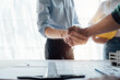 © NanSan - Shaking hands engineer meeting team.
