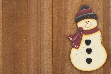 Wall Mural - Snowman holiday background on weathered wood