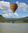 Tourist balloons, balloons floating over the Mekong River in Lao PDR, balloons floating in a beautiful blue sky, balloon group, focus in the upper left corner of the  image, focus in the upper right c